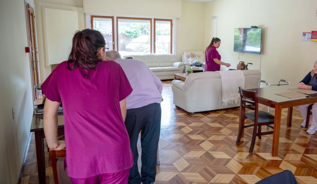 Cuidadoras acompañando a residentes en la sala de estar